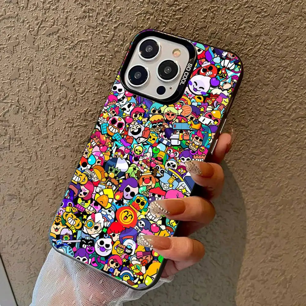 A hand holding a black iPhone case covered in a dense, colorful cartoon character print, set against a textured beige wall.