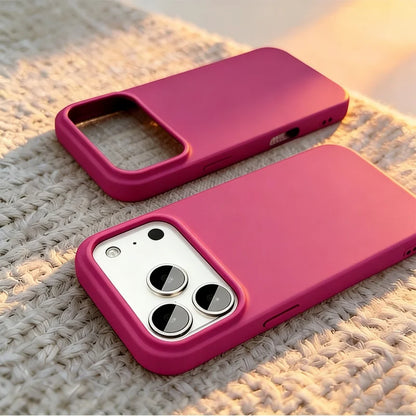 Two magenta pink phone cases shown on a textured beige woven blanket, with one case fitted on a smartphone to demonstrate the camera cutout.