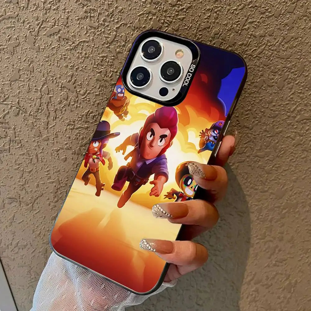 A hand holding a phone case featuring a colorful cartoon illustration of characters in an action scene, shown against a textured beige wall.