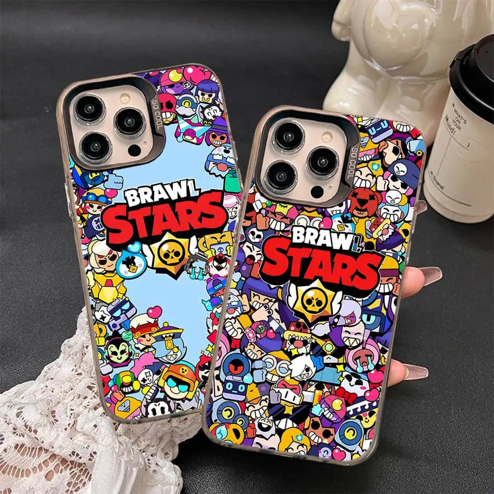 Two clear phone cases with a colorful Brawl Stars cartoon character print, shown on a dark surface with a hand holding one case.