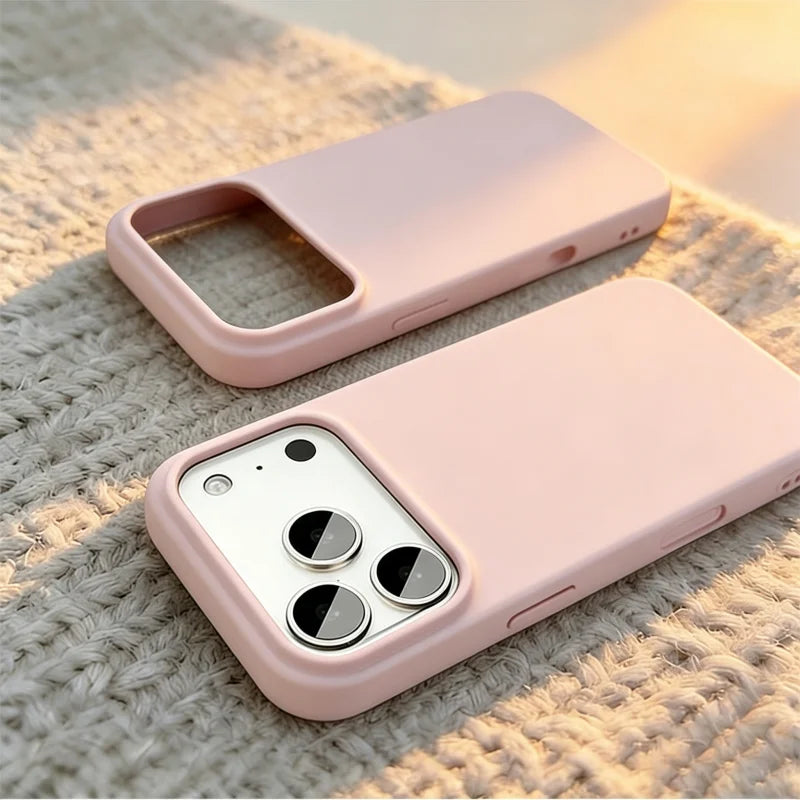 Two light pink phone cases shown on a textured beige knit surface, one empty and one fitted with a silver smartphone.