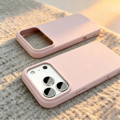 Two light pink phone cases shown on a textured beige knit surface, one empty and one fitted with a silver smartphone.