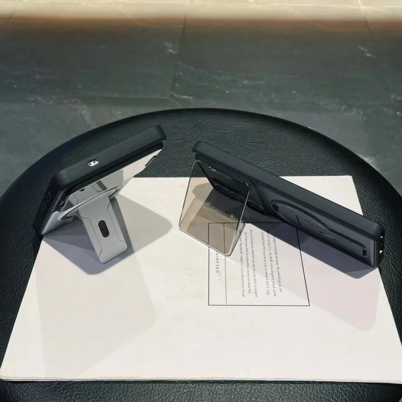 Two black office chair armrests on a black chair with a white paper underneath.