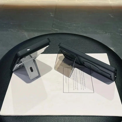 Two black office chair armrests on a black chair with a white paper underneath.