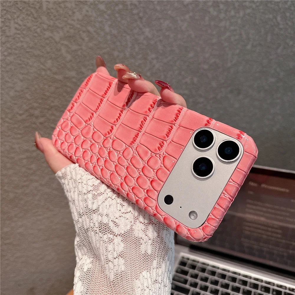Pink textured phone case held by a hand with a blurred background