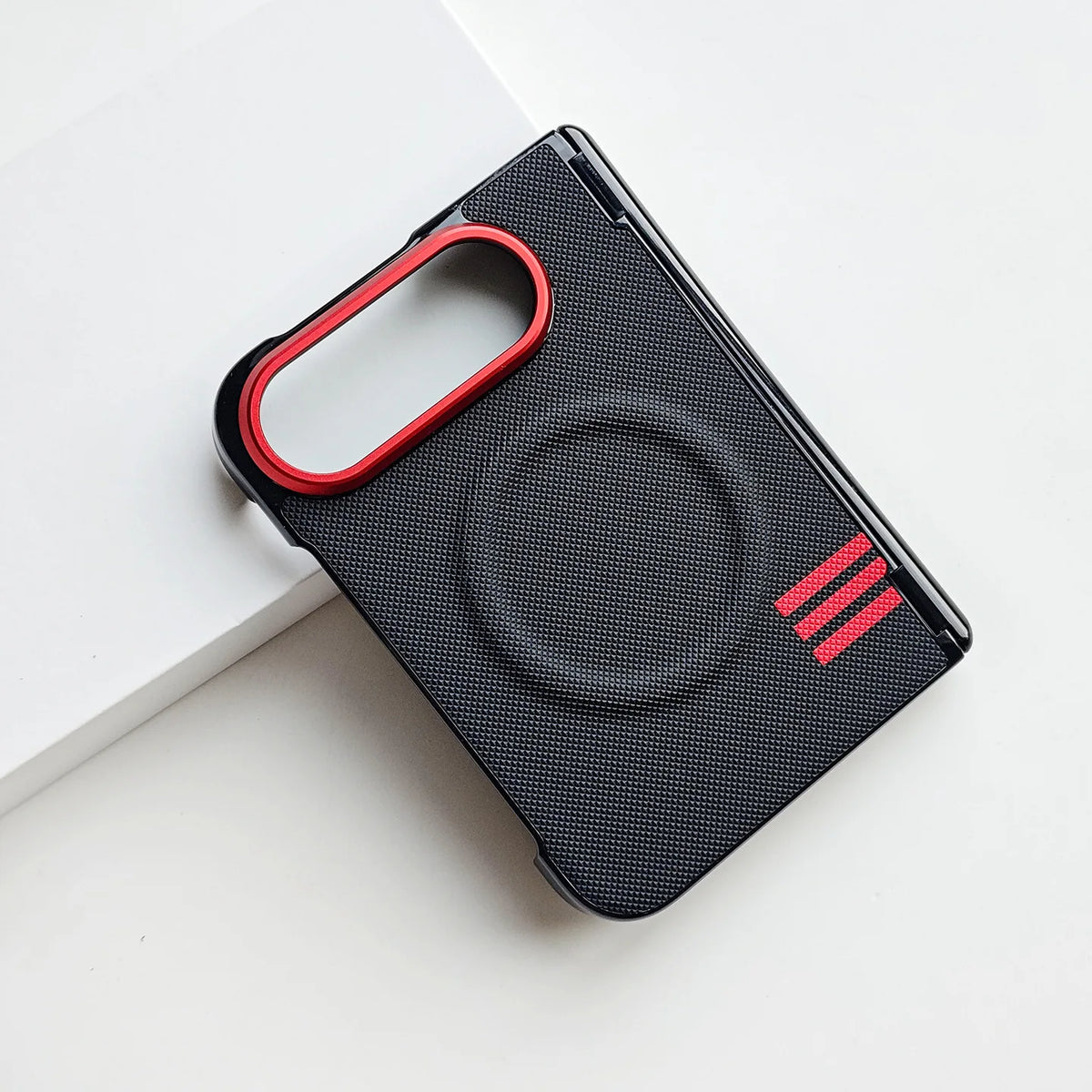 A black textured phone case with a red camera ring and three red stripes on the lower right, shown on a clean white background.