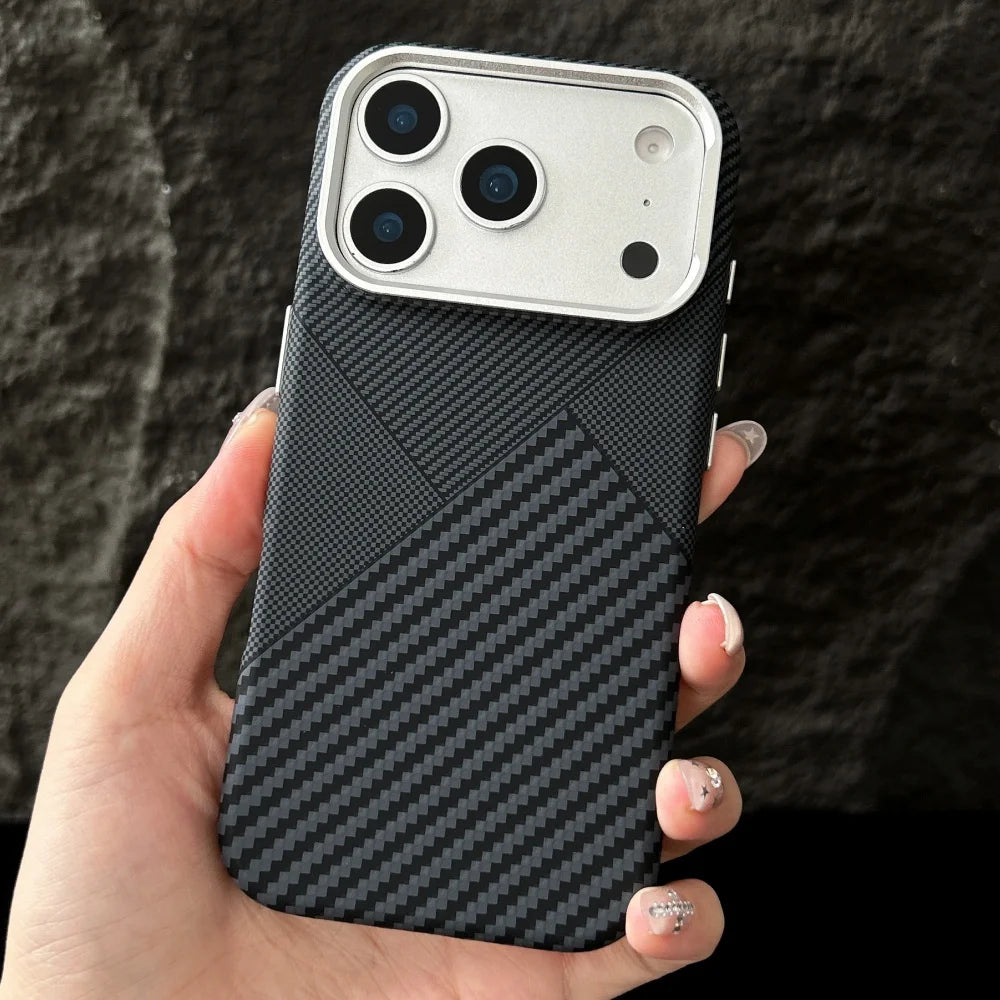 Hand holding a phone with a black carbon fiber texture case against a dark background