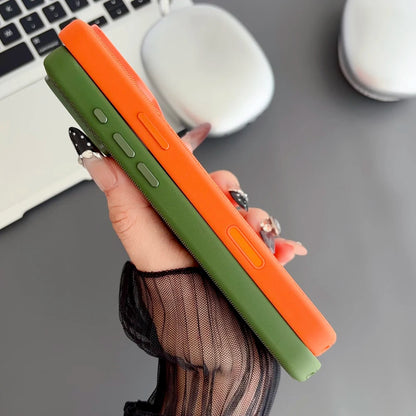 Hand holding a green and orange phone case with a blurred office background