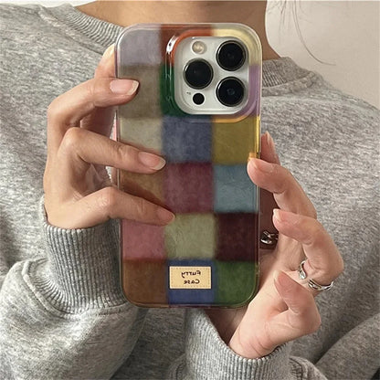 Person holding a phone with a colorful checkered case