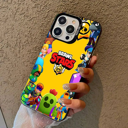 A hand holding a phone case featuring the Brawl Stars logo and various colorful game characters on a bright yellow background, set against a textured beige wall.