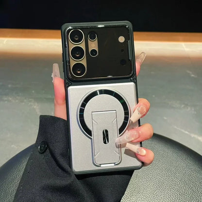 Phone case with stand feature held by a hand against a blurred background