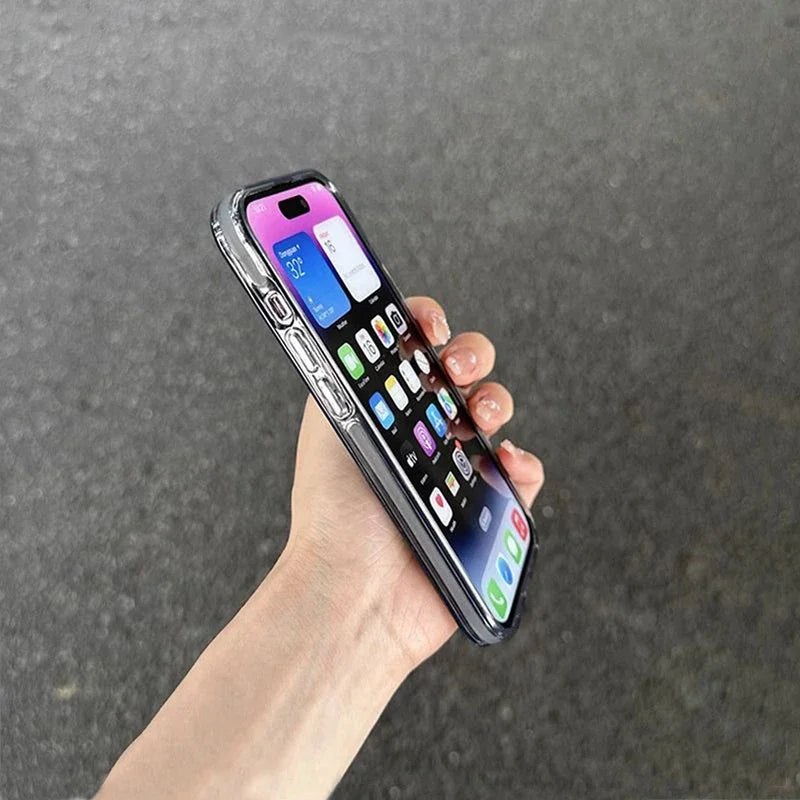 Hand holding a smartphone with a colorful display against a gray background