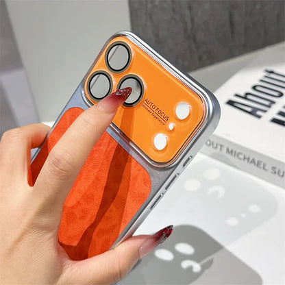 Phone case with orange and silver design held by a hand