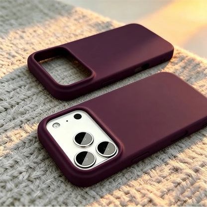 Two dark plum phone cases shown on a textured knit blanket, with one case fitted on a phone to demonstrate the camera cutout.