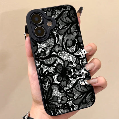 Phone case with black floral lace pattern held by a hand on a beige background
