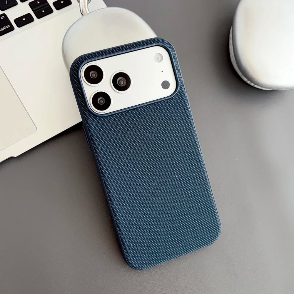 Blue phone case on a desk with a laptop and mug in the background