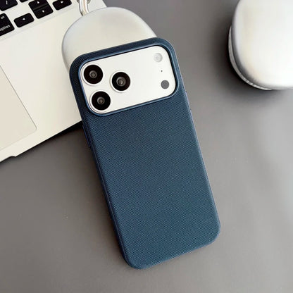 Blue phone case on a desk with a laptop and mug in the background