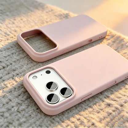 Two light pink phone cases shown on a textured beige woven surface, one empty and one fitted over a white smartphone showing the camera cutout.