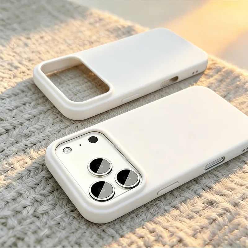 A white matte phone case shown from two angles on a textured beige knit blanket, with a smartphone partially visible inside the case.