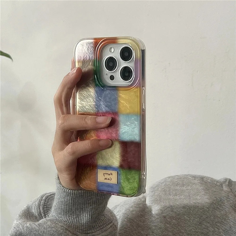 Phone case with colorful block pattern held by a person against a neutral background