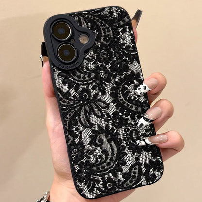 Phone case with black lace pattern held by a hand against a beige background