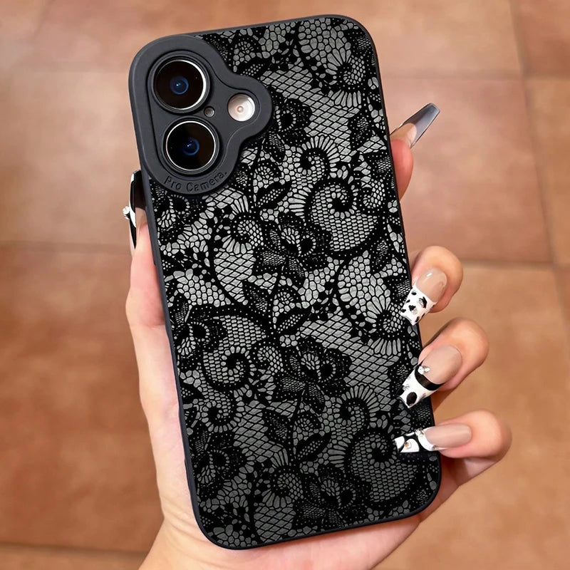 Phone case with black lace pattern held by a hand on a wooden surface
