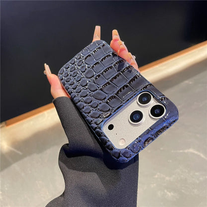 Hand holding a phone case with a textured design against a neutral background