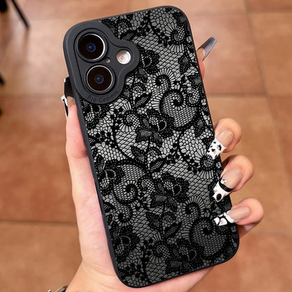 Phone case with black lace pattern held in a hand on a wooden floor.