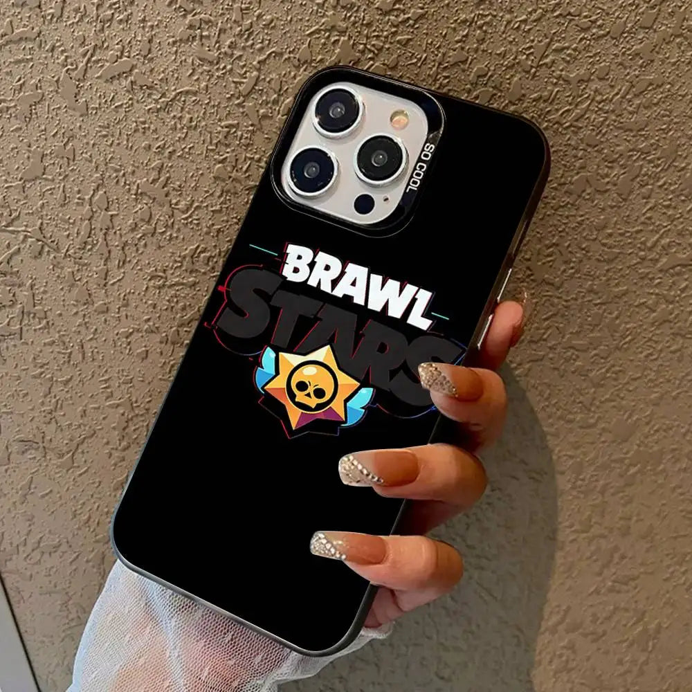 A hand holding a black phone case featuring the Brawl Stars logo and star graphic, shown against a textured beige wall.