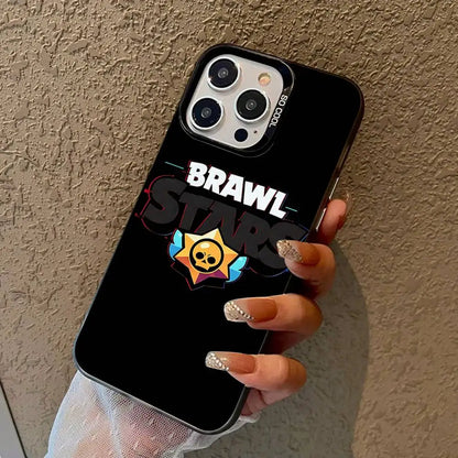 A hand holding a black phone case featuring the Brawl Stars logo and star graphic, shown against a textured beige wall.
