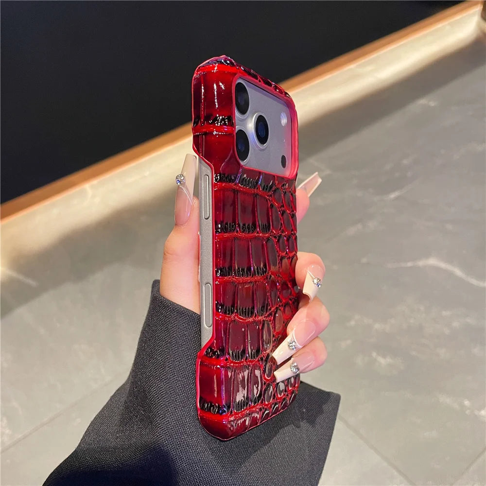 Red crocodile pattern phone case held by a hand on a neutral background