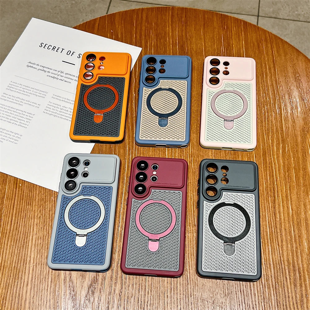 Six smartphone cases arranged on a wooden table, each with a different color and a circular MagSafe ring. The cases are orange, blue, light pink, light blue, burgundy, and dark gray.