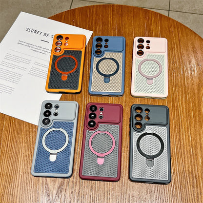 Six smartphone cases arranged on a wooden table, each with a different color and a circular MagSafe ring. The cases are orange, blue, light pink, light blue, burgundy, and dark gray.