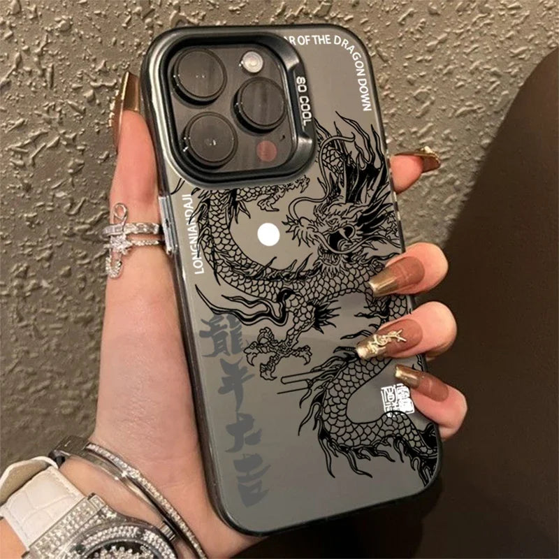 Phone case with dragon design held by a person against a textured wall.