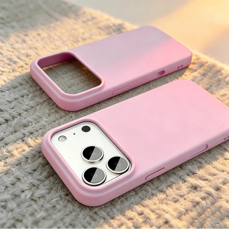 Two light pink phone cases shown on a textured beige knit surface, one empty and one fitted with a white smartphone.