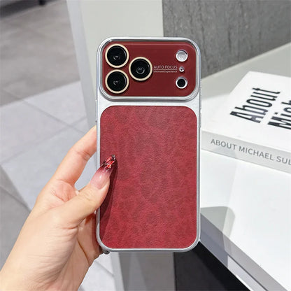A hand holds a red textured phone case with a built-in magnetic card slot, shown against a modern indoor background with a book.