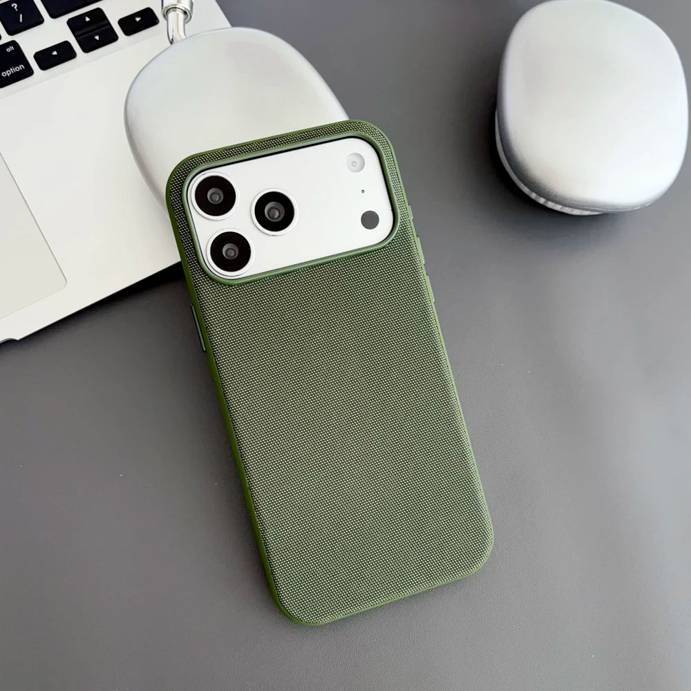 Green phone case on a gray surface with a laptop and mouse in the background