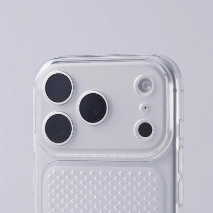 A close-up of a clear protective phone case fitted over a white smartphone, showing the transparent bumper edge and a textured grip panel on the back, set against a light gray background.