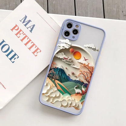 Phone case with a mountain and cloud design on a white surface with a coffee cup and book.