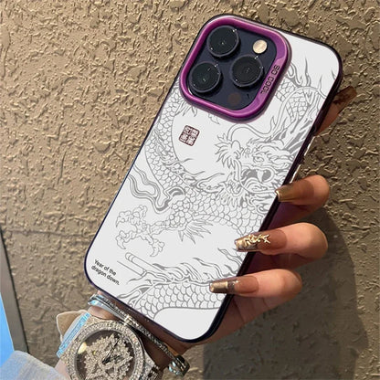 Phone case with dragon design held by a hand against a textured wall.